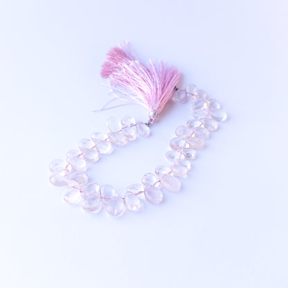 Handmade jewellery components featuring natural rose quartz smooth briolettes with soft tones and polished glow.