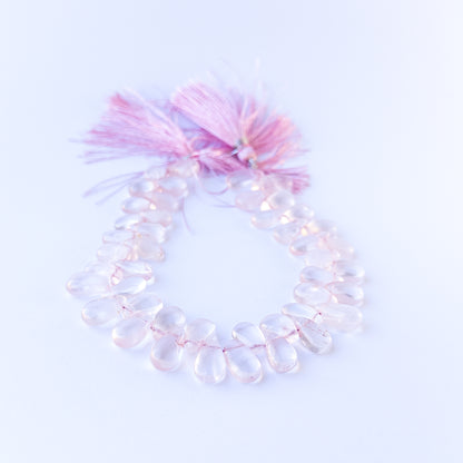 High‑quality rose quartz briolette gemstone beads with gentle shine and natural colour variation on a long strand.