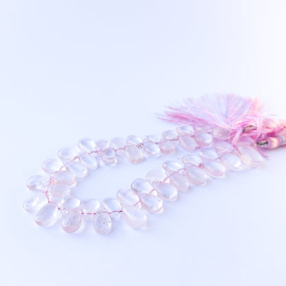 Premium rose quartz gemstone beads for DIY jewellery, displaying smooth briolette cuts and delicate pastel colour.