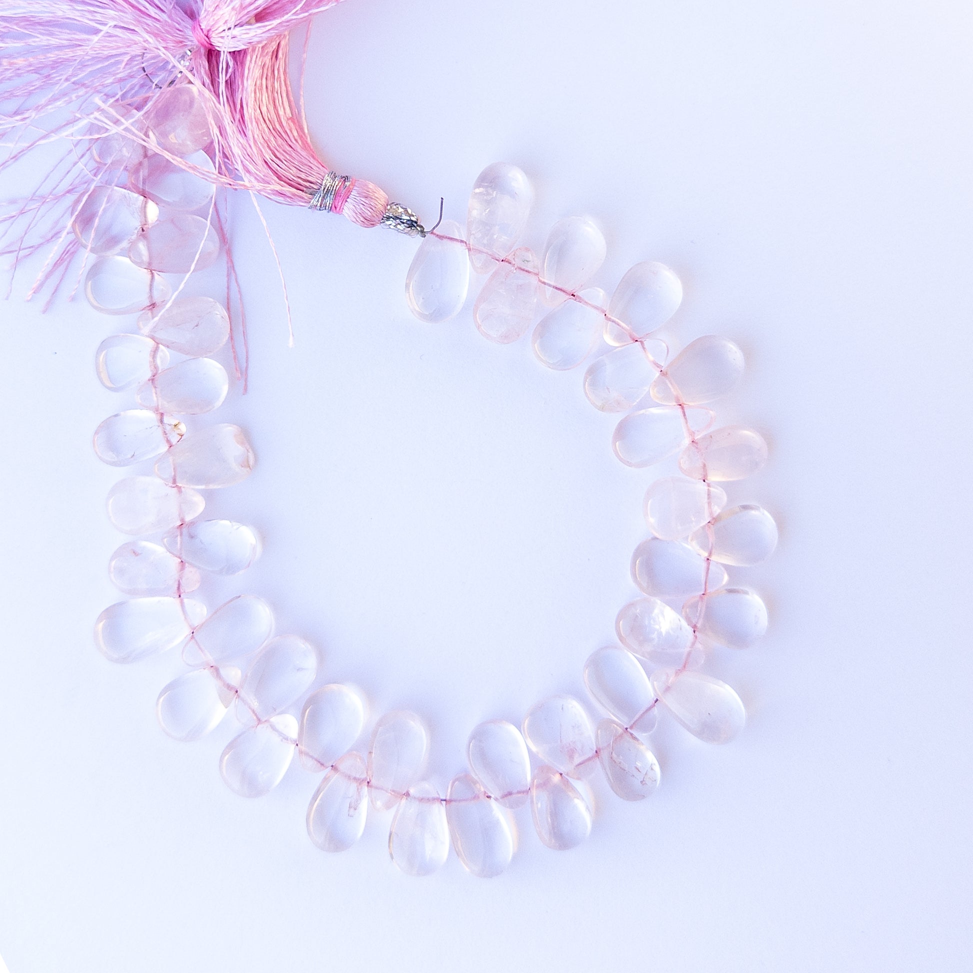 Rose Quartz smooth briolette beads in 8–8.7mm size on a 23cm strand, showcasing genuine gemstone shine.