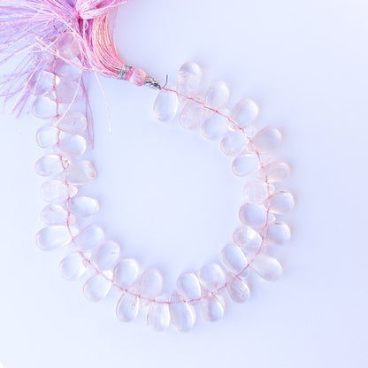 Rose Quartz smooth briolette beads in 8–8.7mm size on a 23cm strand, showcasing genuine gemstone shine.