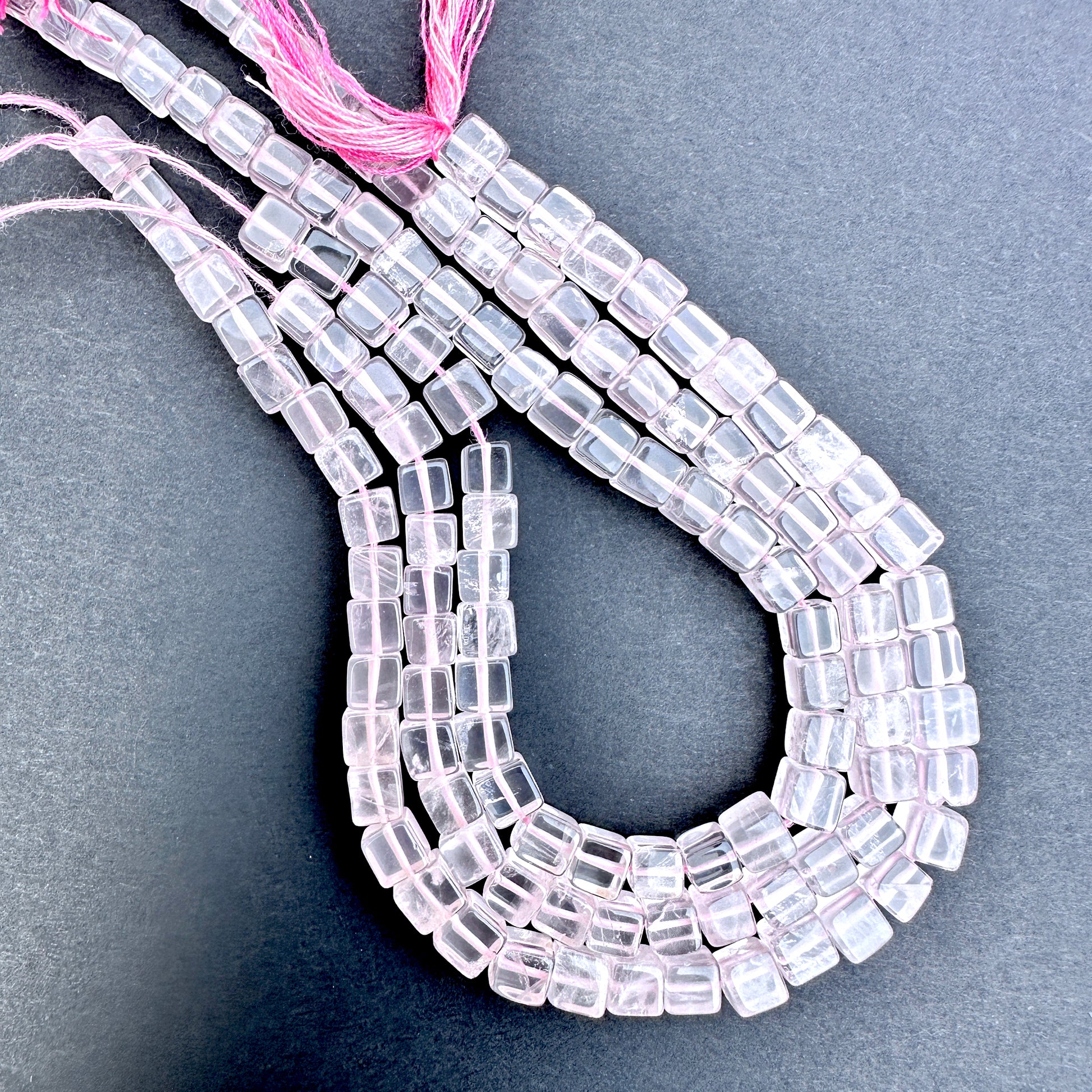 Close-up of Rose Quartz smooth square beads with soft pink tones and polished finish.