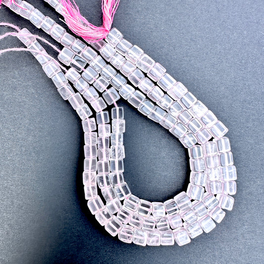 Close-up of Rose Quartz smooth square beads with soft pink tones and polished finish.