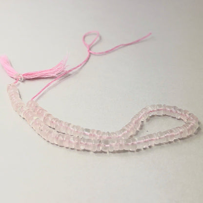 Rose Quartz smooth wheel beads aligned on a strand, highlighting colour, clarity and quality stone beads.