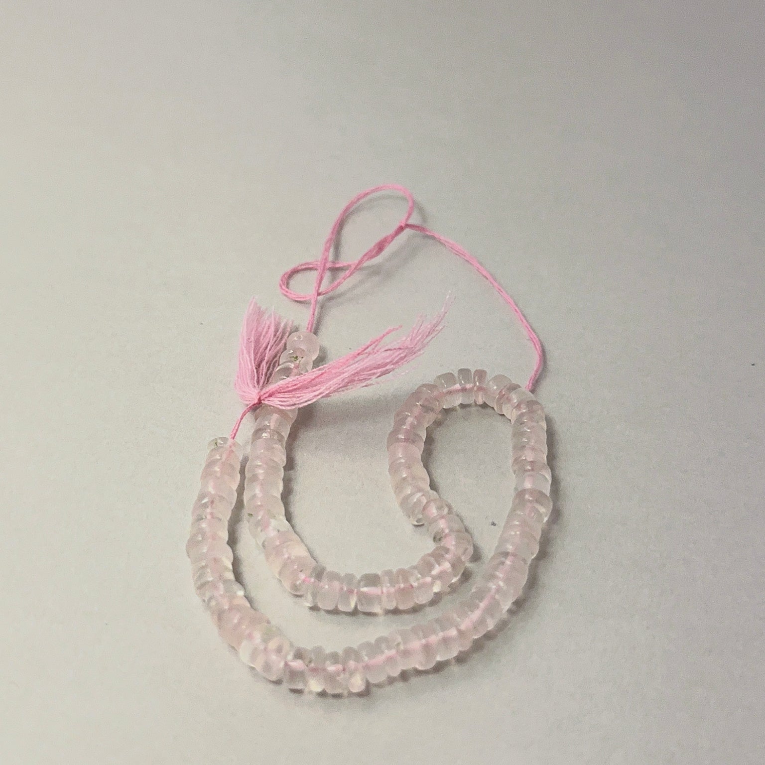 Detailed Rose Quartz 5mm wheel beads showing soft pastel hues, ideal for gemstone beads for DIY jewellery.