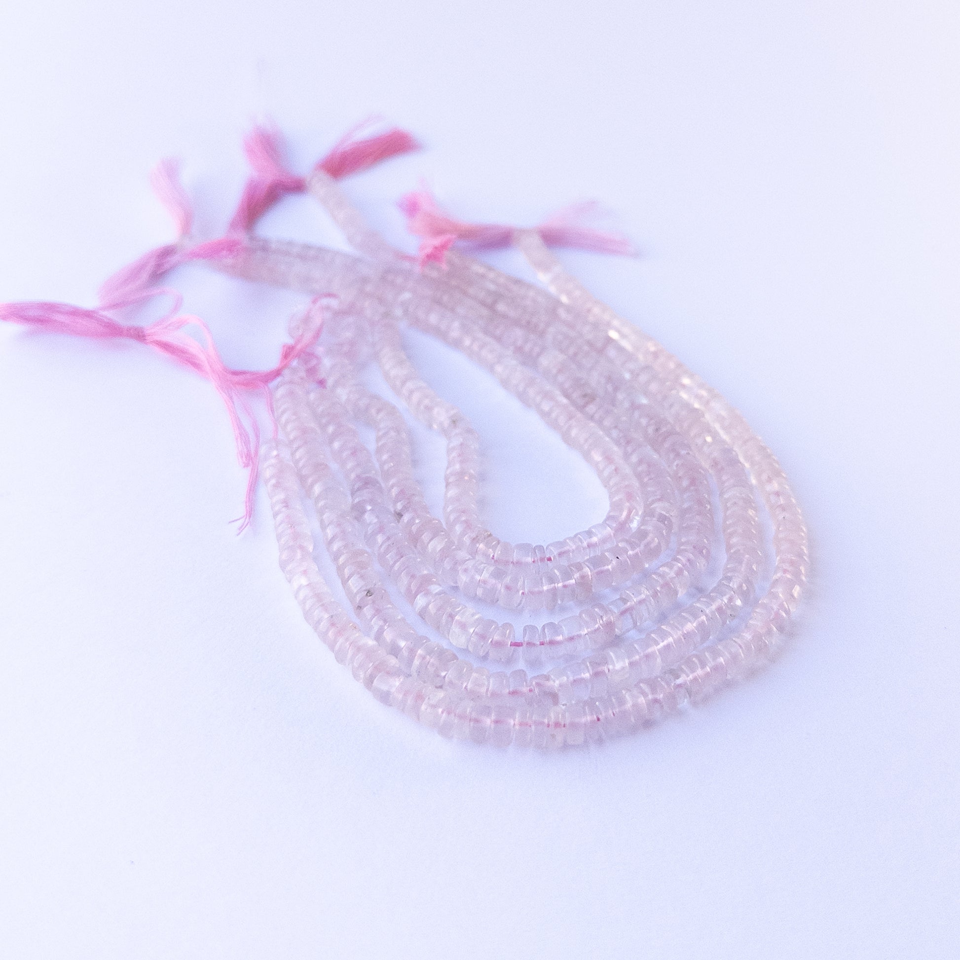 Premium rose quartz gemstone beads for DIY jewellery, displaying smooth wheel cuts and delicate pink colour.