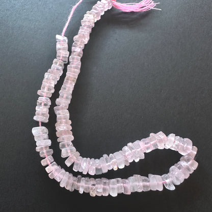 Close-up of Rose Quartz beads showcasing their polished surface and delicate colour.
