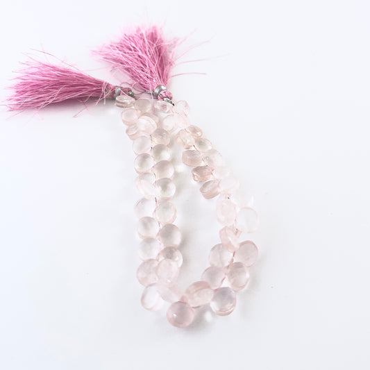 Rose Quartz faceted briolette beads sized 8–8.5mm arranged in a 20cm strand, showing soft pink tones and sparkling facets.