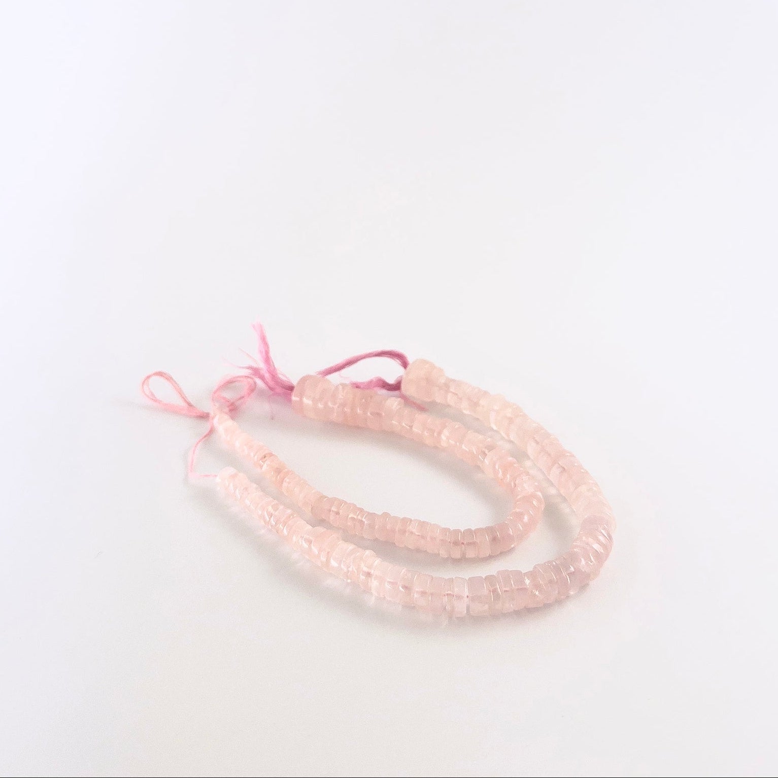 Rose Quartz smooth wheel gemstones with rounded shaping and gentle blush colour across a 19cm strand.