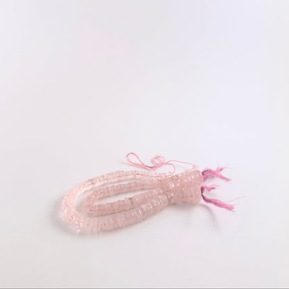 Rose Quartz gemstones in smooth wheel form, offering a sleek finish and pastel pink colouring.