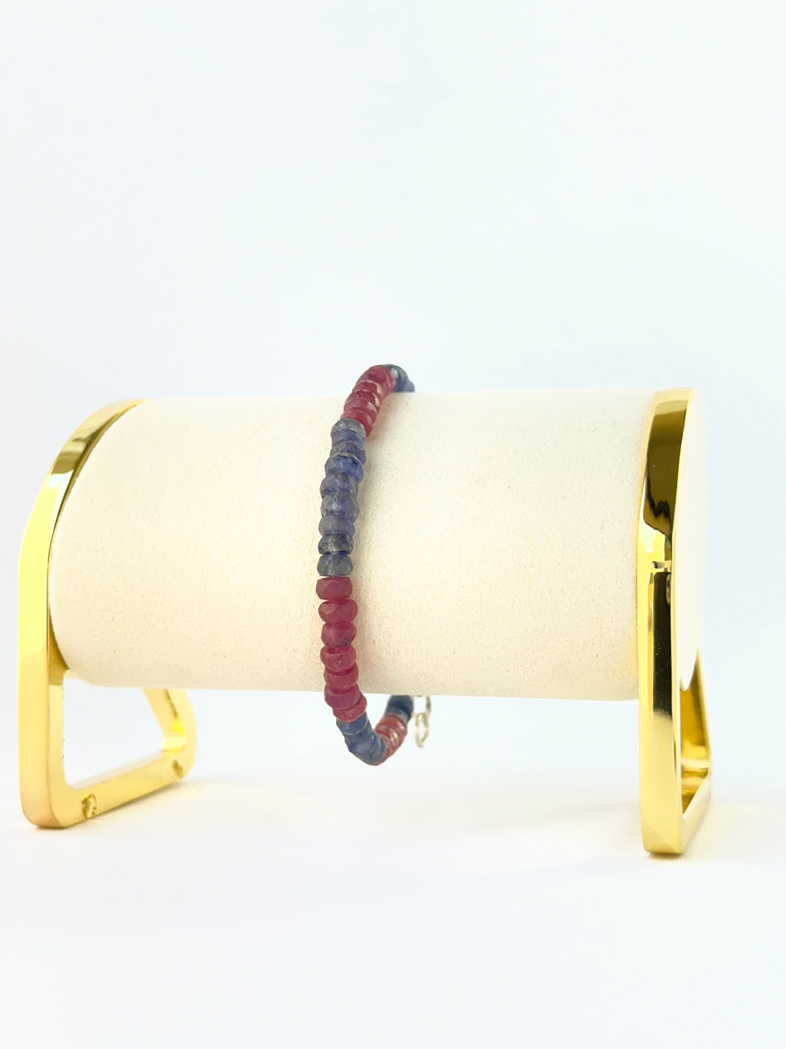 Ruby and blue sapphire bead bracelet arranged in a single adjustable strand.