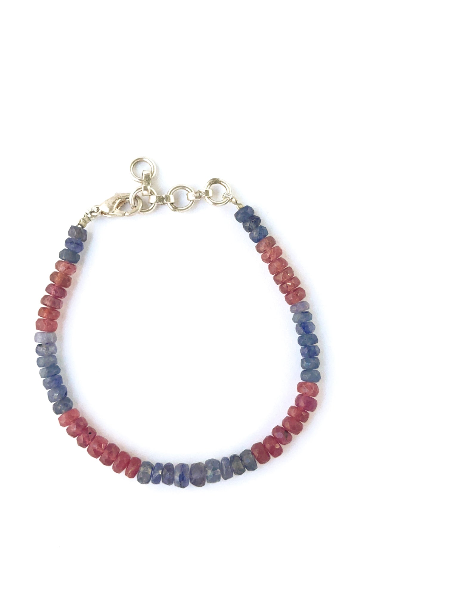 Multi‑gemstone bracelet showcasing faceted 5mm ruby and sapphire rondelle beads.