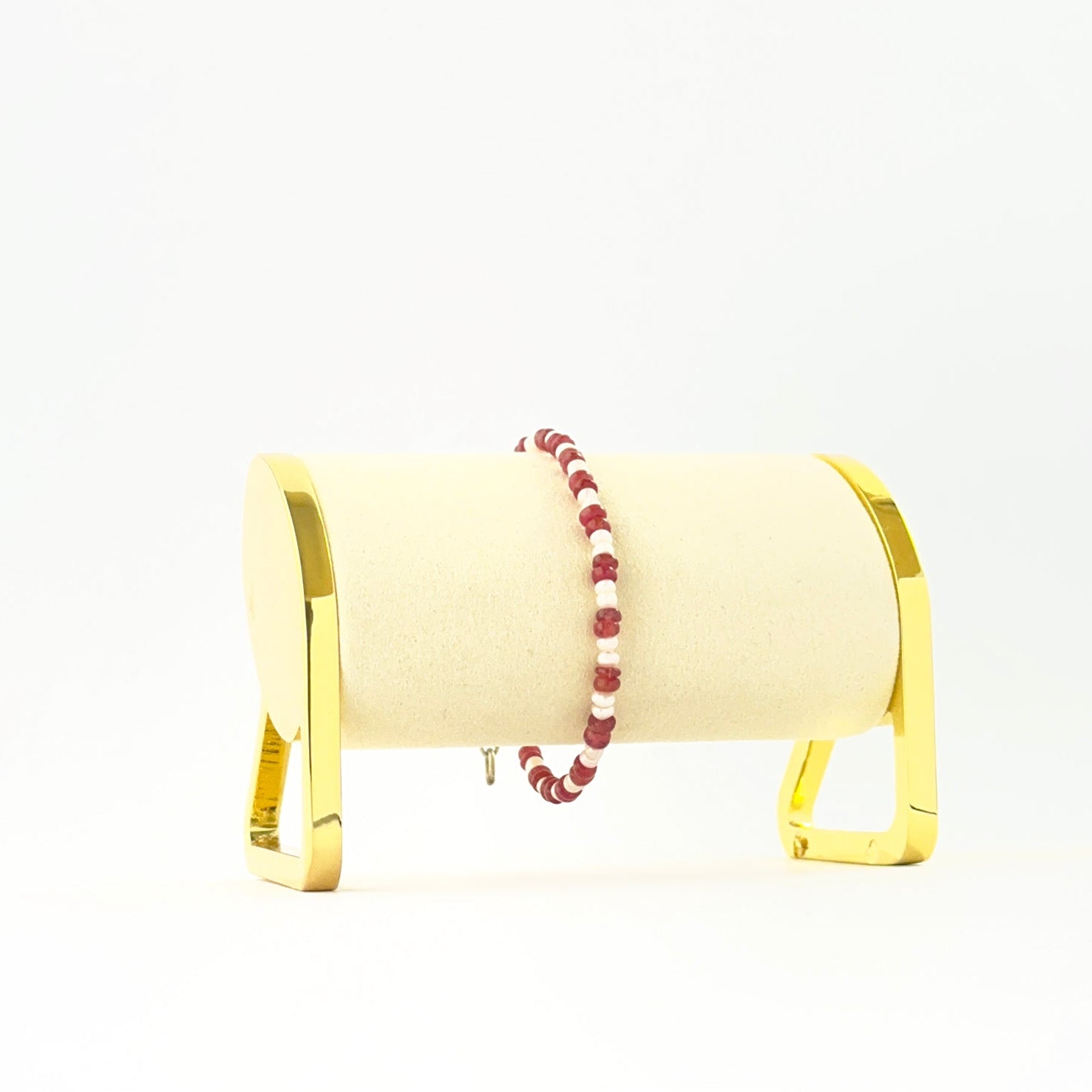 Elegant ruby and pearl bracelet showcasing smooth rondelle beads in a single 18cm strand.