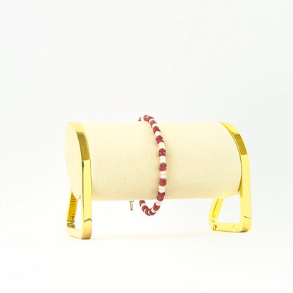 Elegant ruby and pearl bracelet showcasing smooth rondelle beads in a single 18cm strand.