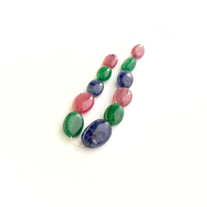 Multi precious smooth oval beads showing ruby, sapphire and emerald colours for handmade jewellery.