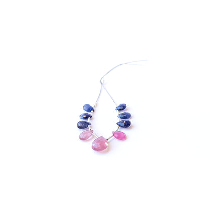 Ruby and Blue Sapphire briolette gemstone beads displaying polished facets and rich colour tones.
