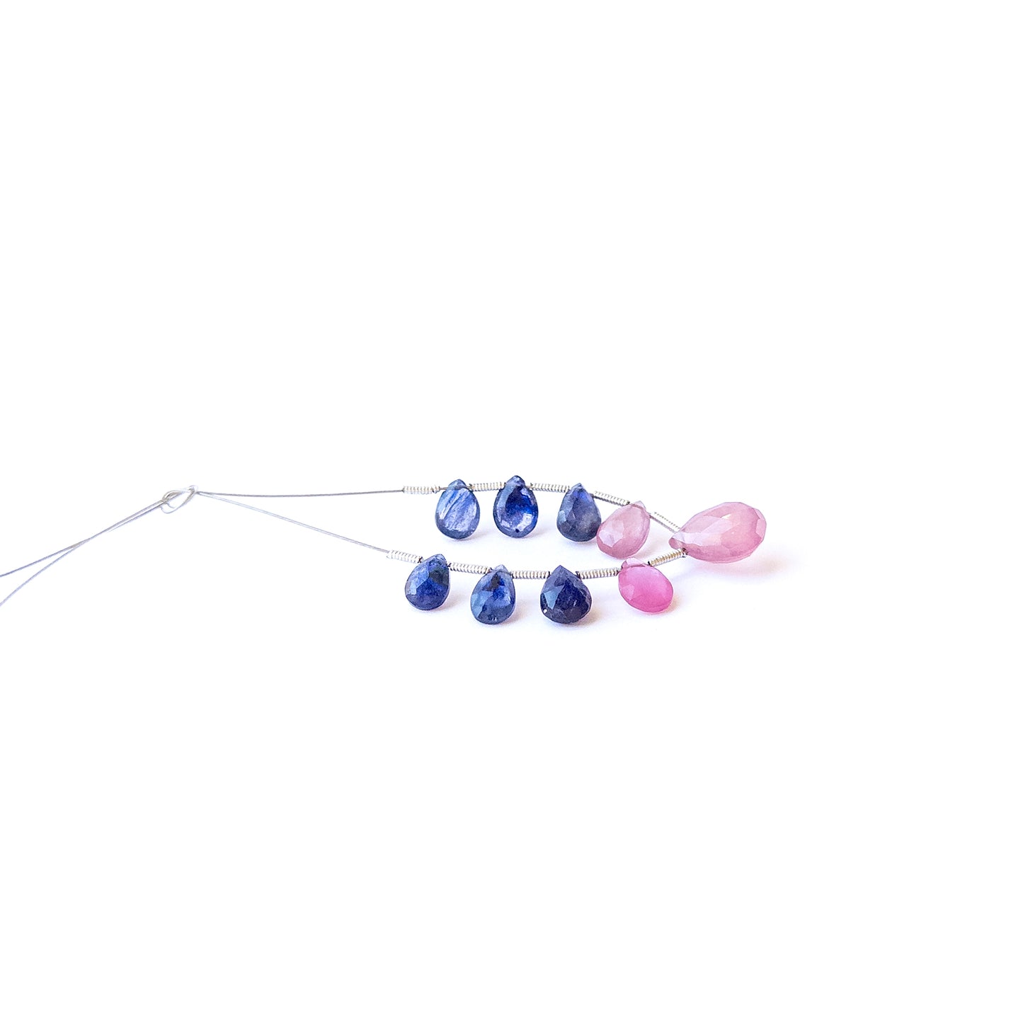 Genuine stone beads featuring Ruby and Blue Sapphire briolettes with radiant gemstone clarity.