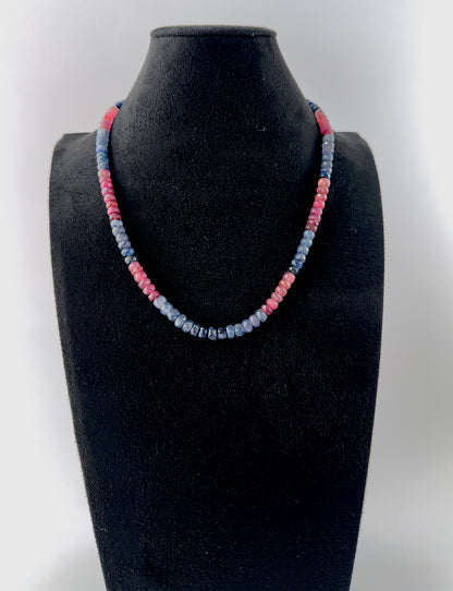 Handcrafted necklace combining Ruby and Blue Sapphire gemstone beads, cut in faceted rondelle shapes for refined shine.