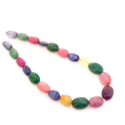 Multi stone smooth oval beads 8x6–11x7mm featuring ruby, blue sapphire, yellow sapphire and emerald, 21 pieces, 67 carats.