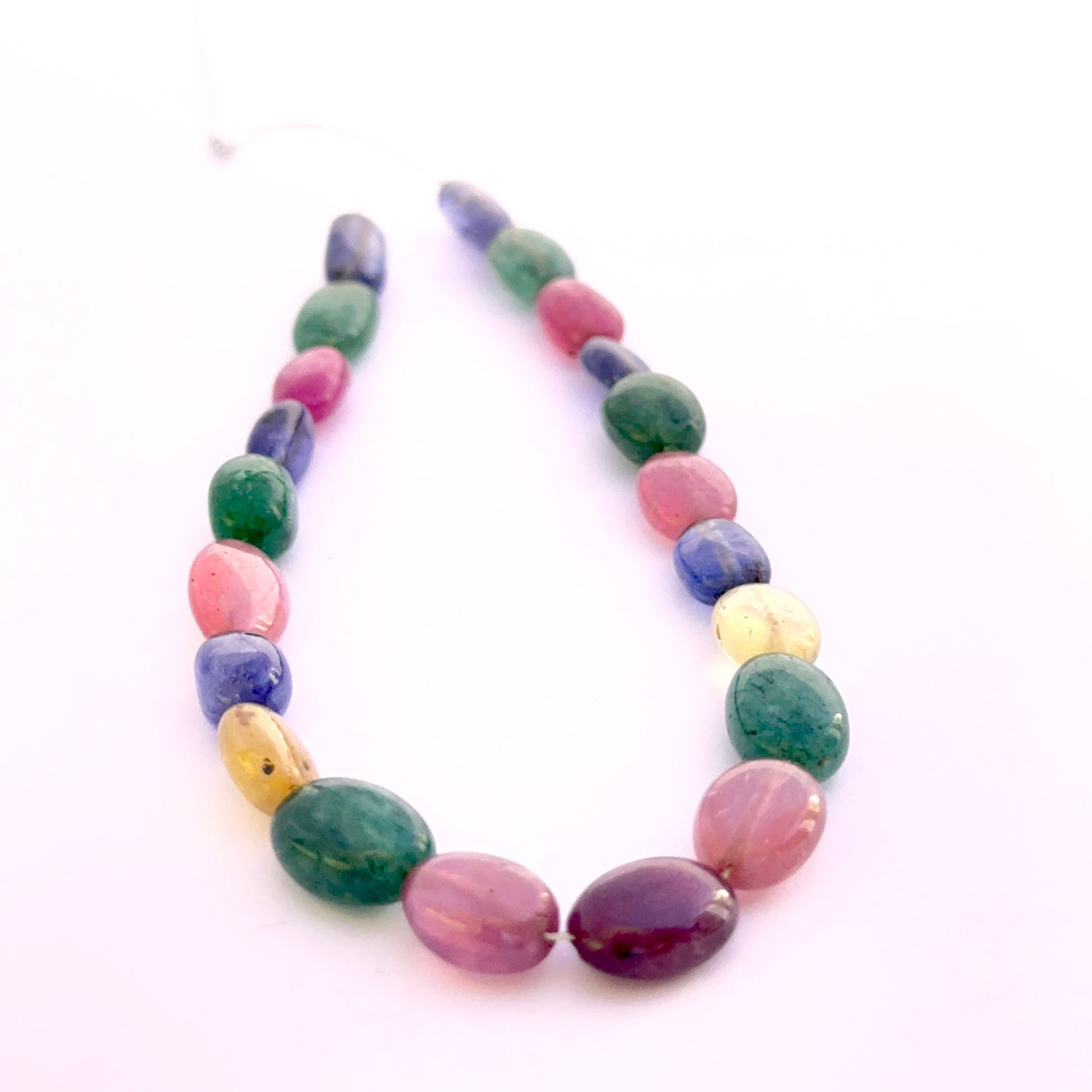 Set of 21 smooth oval multi stone beads 8x6–11x7mm totalling 67 carats, ideal for bespoke jewellery and settings.
