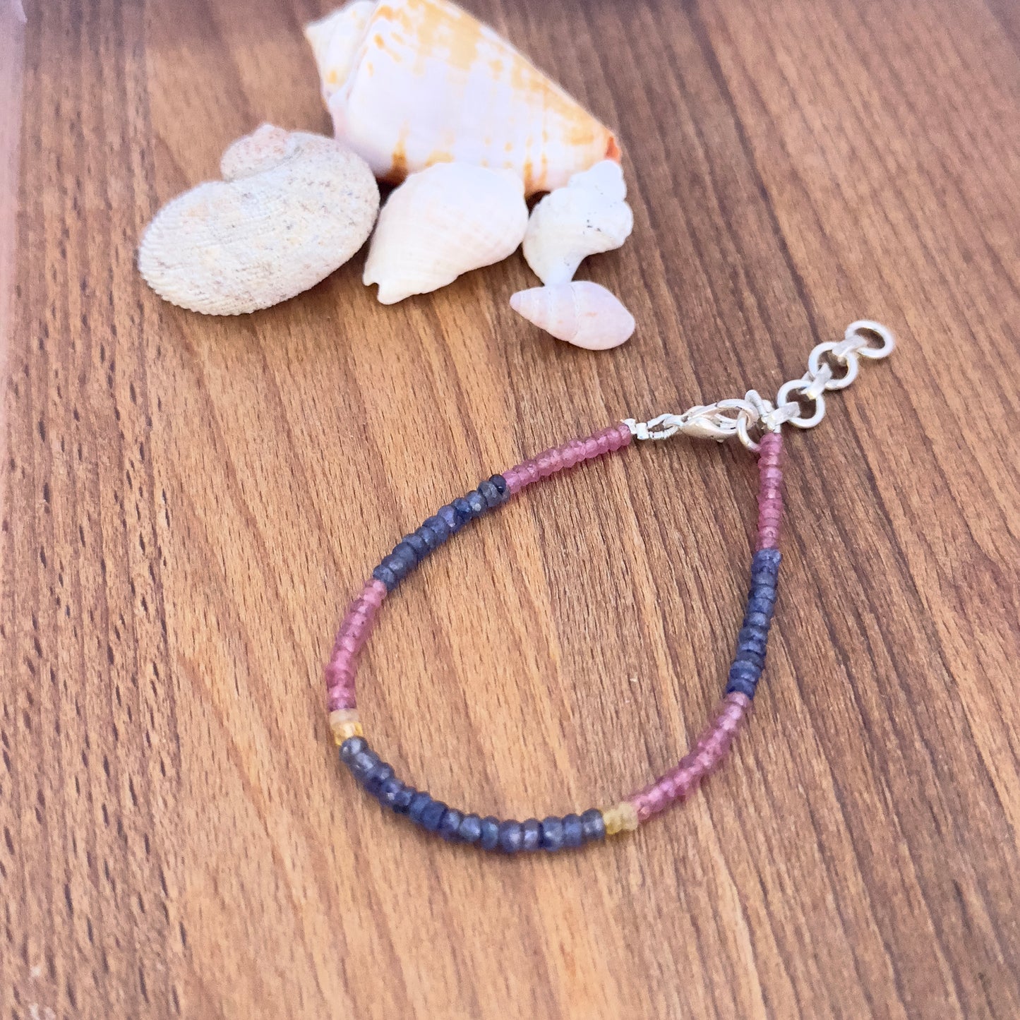 Faceted rondelle Ruby, Blue & Yellow Sapphire beads in 3.5mm size strung on a 17.5cm adjustable bracelet. 