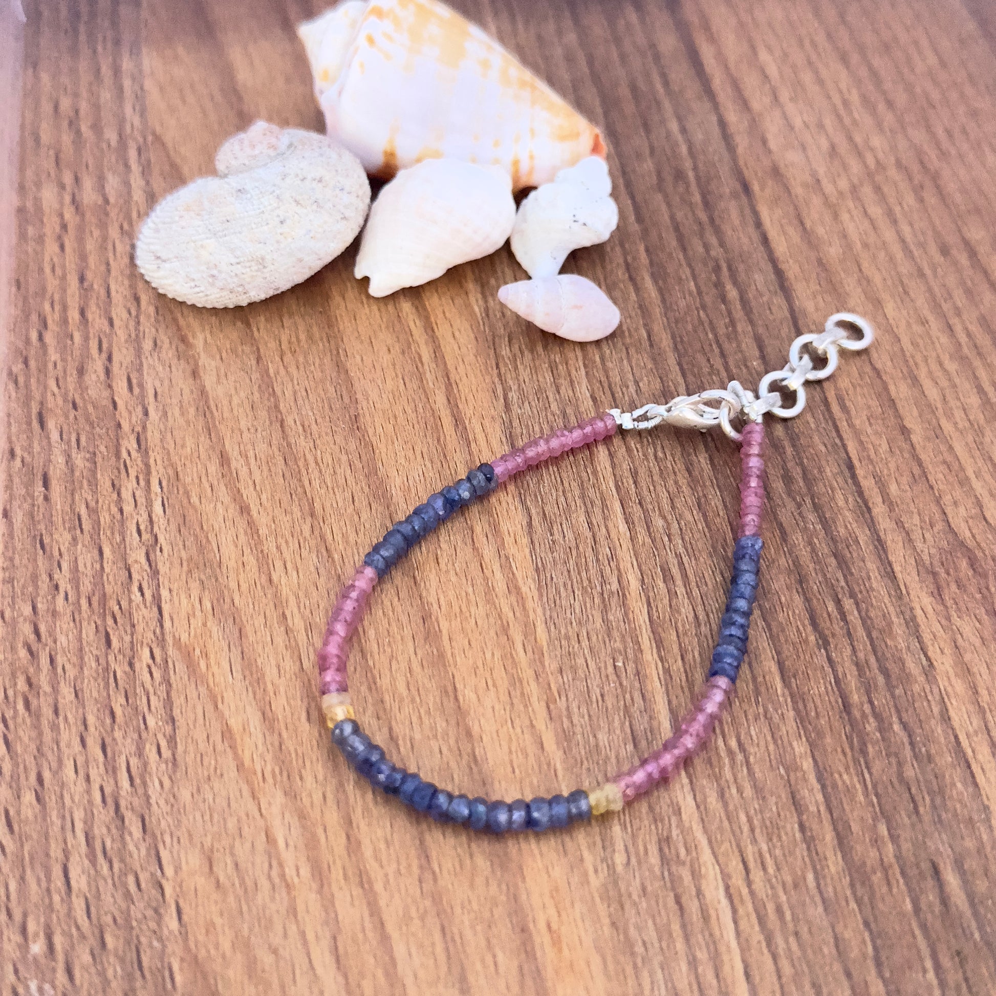 Faceted rondelle Ruby, Blue & Yellow Sapphire beads in 3.5mm size strung on a 17.5cm adjustable bracelet. 