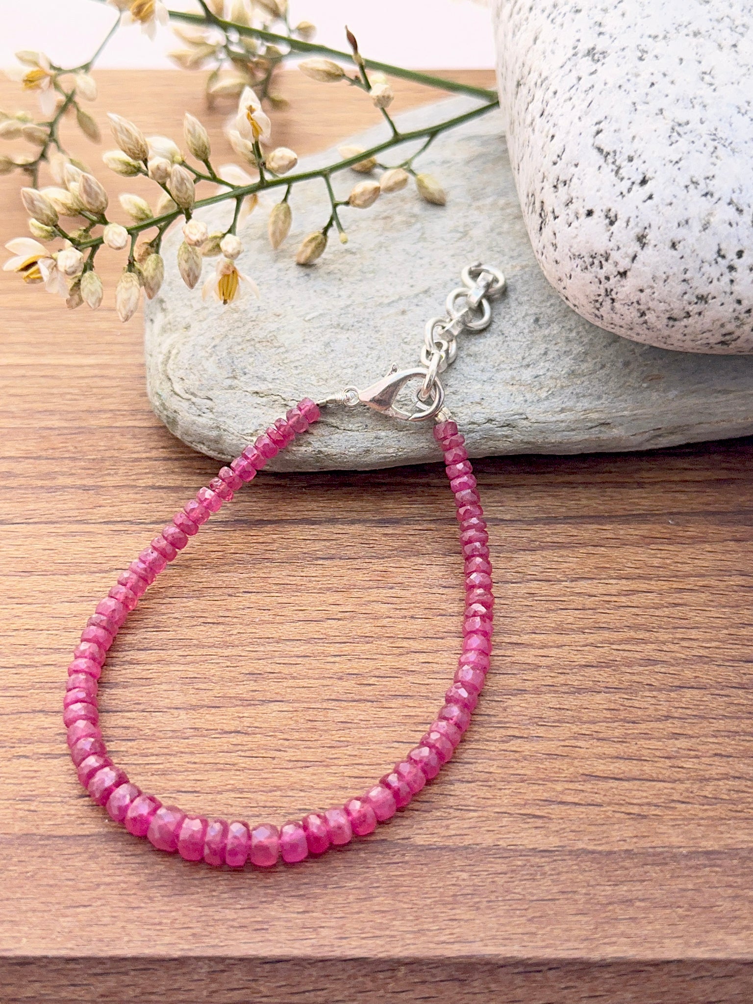Ruby bracelet with sparkling rondelle beads showing shine.