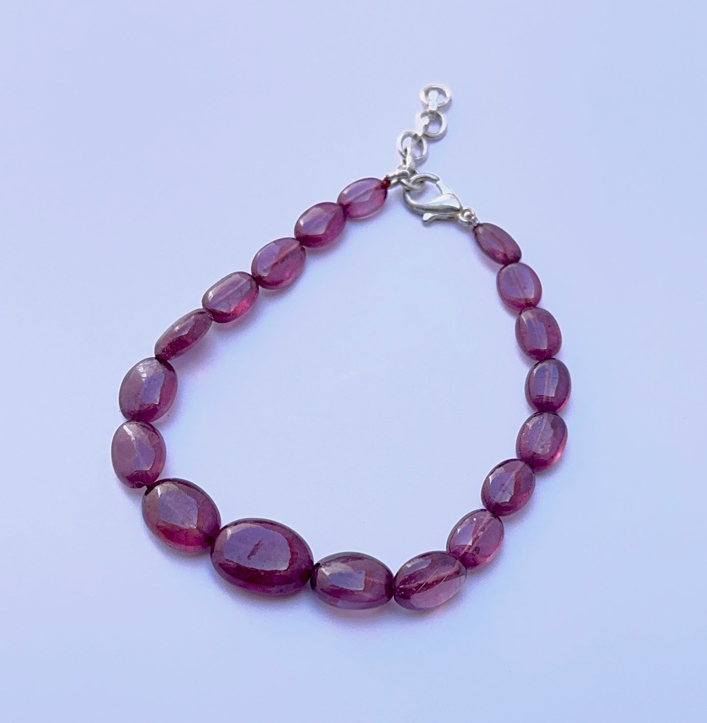 Ruby bracelet with smooth oval beads arranged in a bold design.