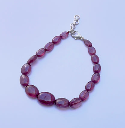 Ruby bracelet with smooth oval beads arranged in a bold design.