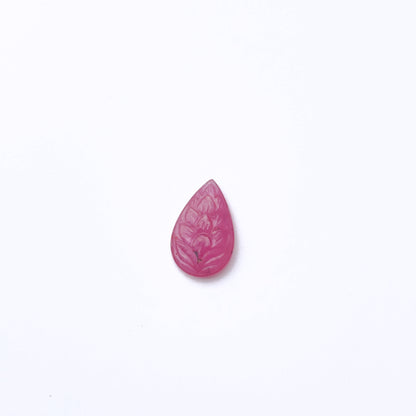 Ruby carved gemstone in deep red tones showing detailed craftsmanship.