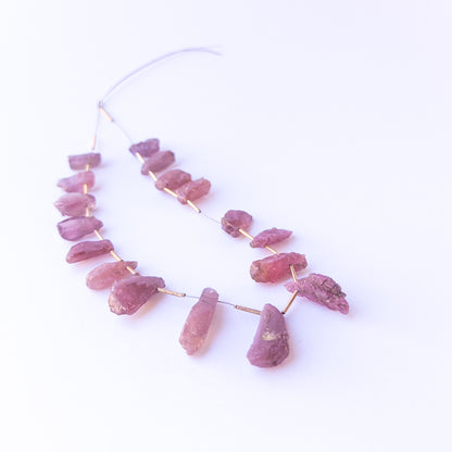 Ruby drilled rough beads in 7–10mm size, showcasing natural texture and genuine gemstone richness.