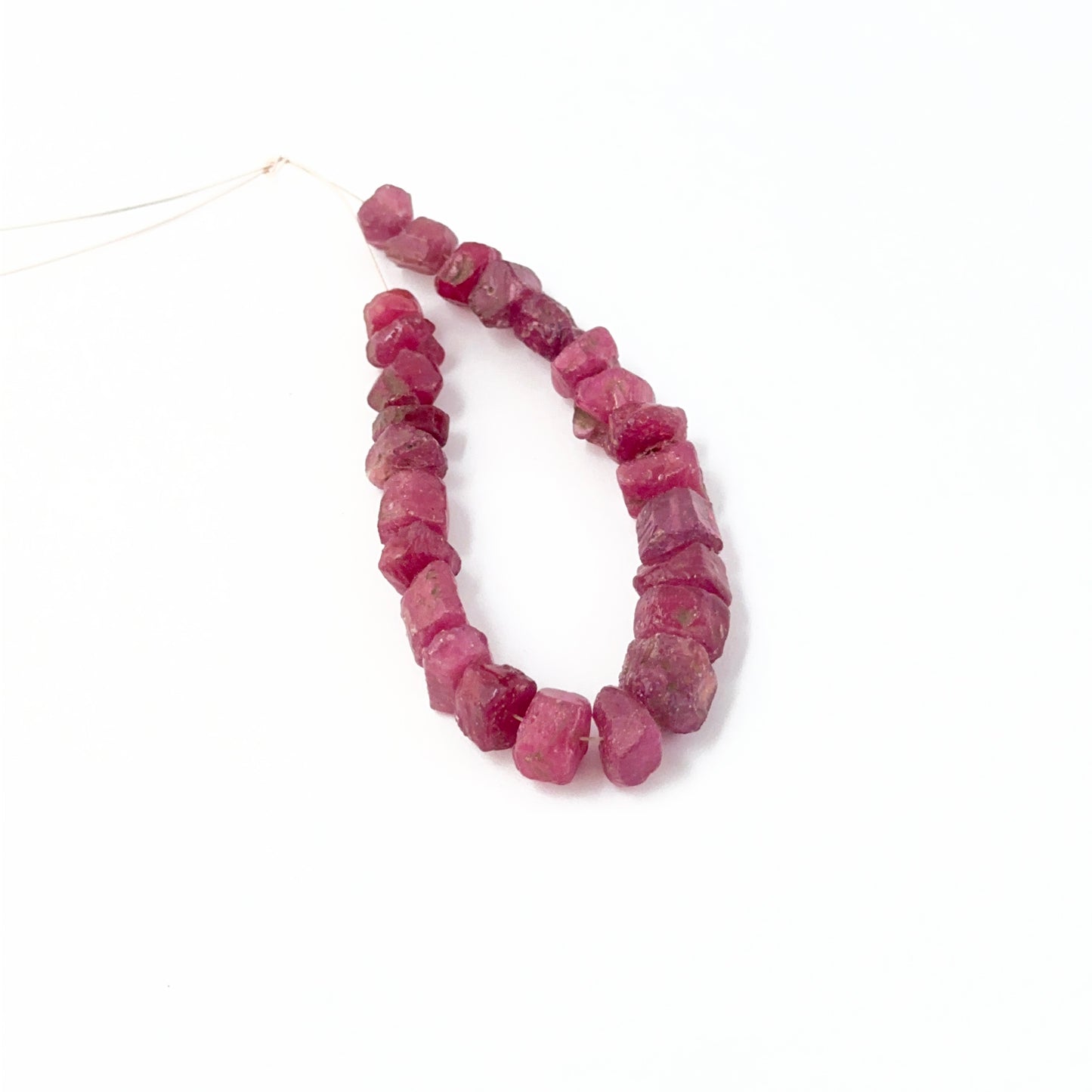 Ruby 7–9mm drilled rough stones with bold colour and rugged gemstone texture.