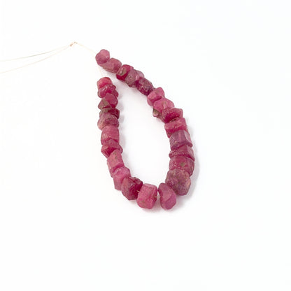 Ruby 7–9mm drilled rough stones with bold colour and rugged gemstone texture.