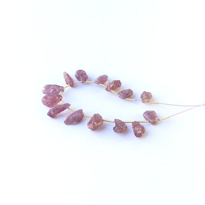 Authentic Ruby drilled rough beads showcasing organic crystal form and vibrant red hues.