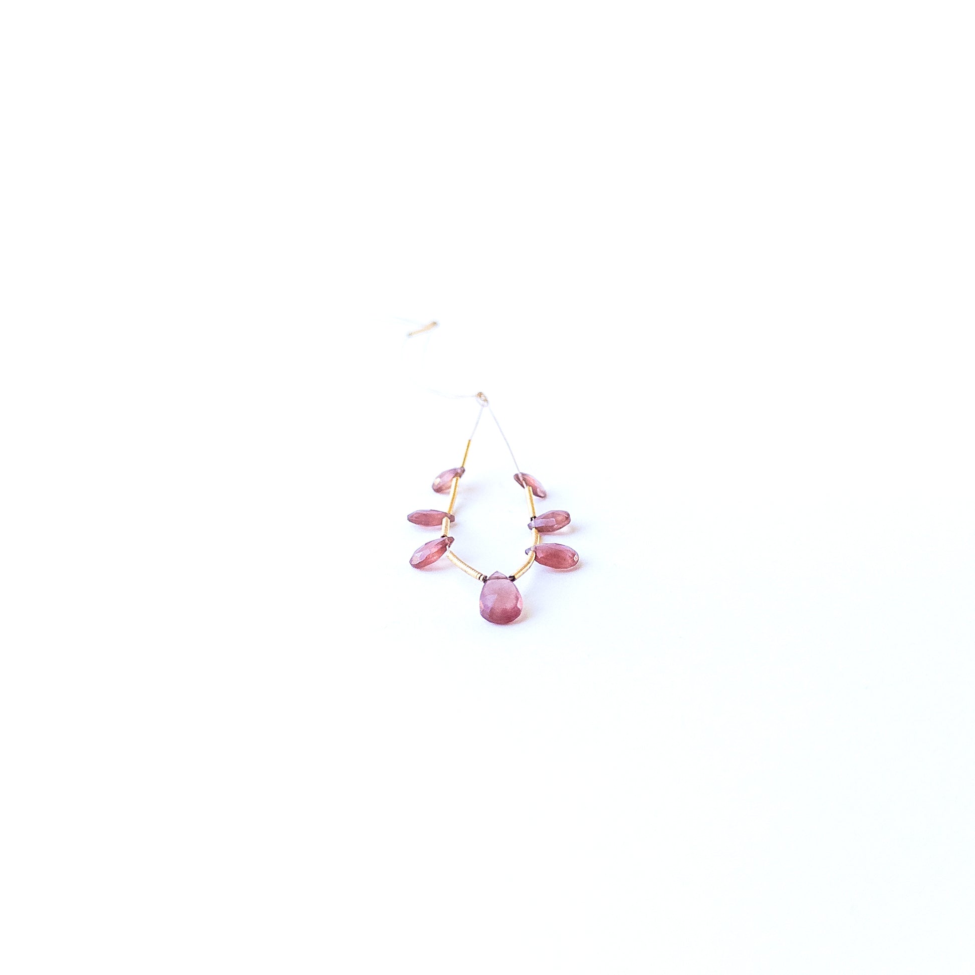 Close‑up of genuine Ruby faceted briolette stone beads showing polished facets and natural gemstone shine.
