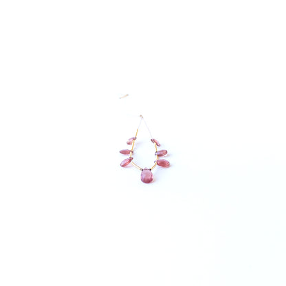 Close‑up of genuine Ruby faceted briolette stone beads showing polished facets and natural gemstone shine.