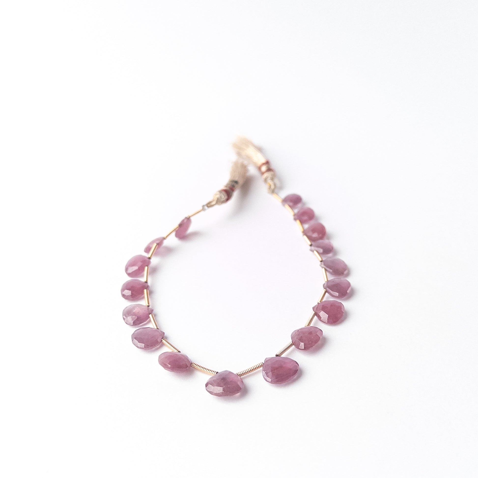 Shimmering Ruby briolette beads with teardrop shaping, genuine stone beads ideal for detailed beadwork and crafting.