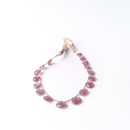 Shimmering Ruby briolette beads with teardrop shaping, genuine stone beads ideal for detailed beadwork and crafting.