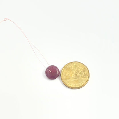 High‑quality faceted Ruby bead for handcrafted necklaces and jewellery projects, placed next to a coin for scale.