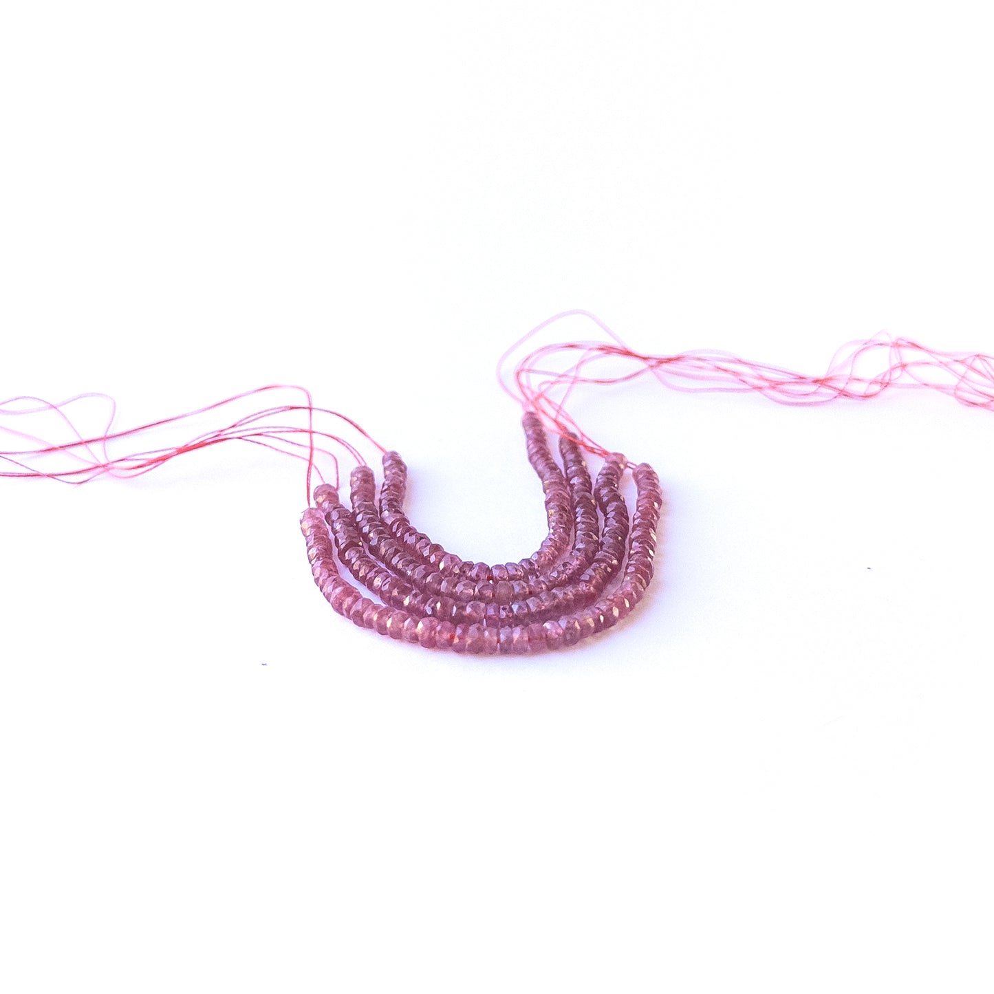 Close‑up of genuine ruby faceted rondelle gemstone beads with natural sparkle for DIY jewellery making.