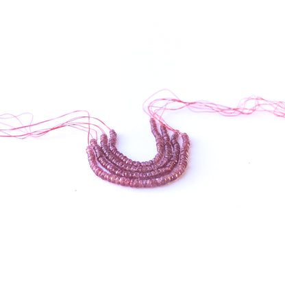Close‑up of genuine ruby faceted rondelle gemstone beads with natural sparkle for DIY jewellery making.