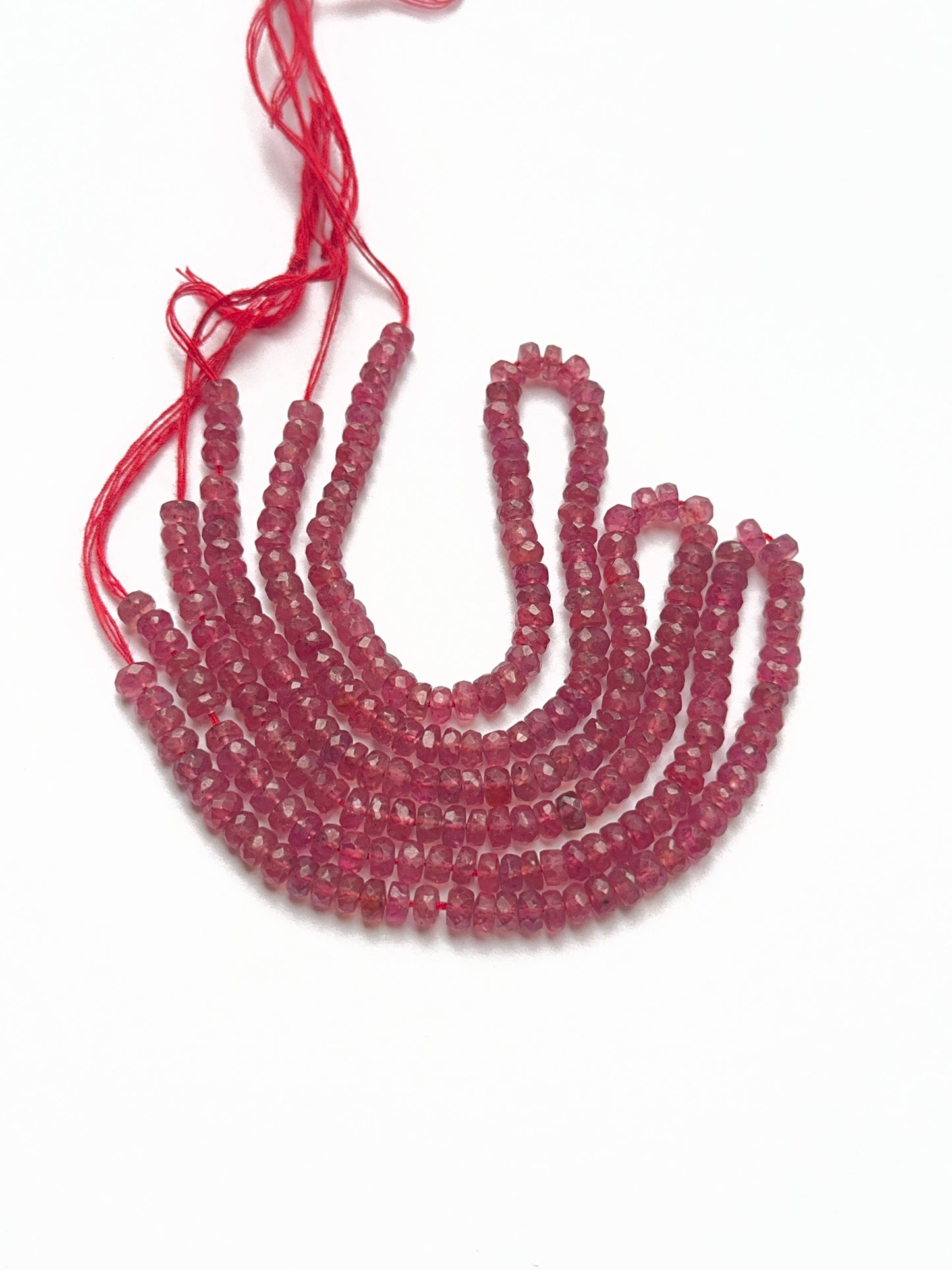 Deep red ruby rondelle beads arranged in a 20cm strand, perfect gemstone beads for elegant jewellery designs.