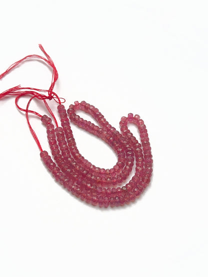 Close-up of ruby faceted rondelles highlighting their sparkle, smooth arrangement, and premium stone bead craftsmanship