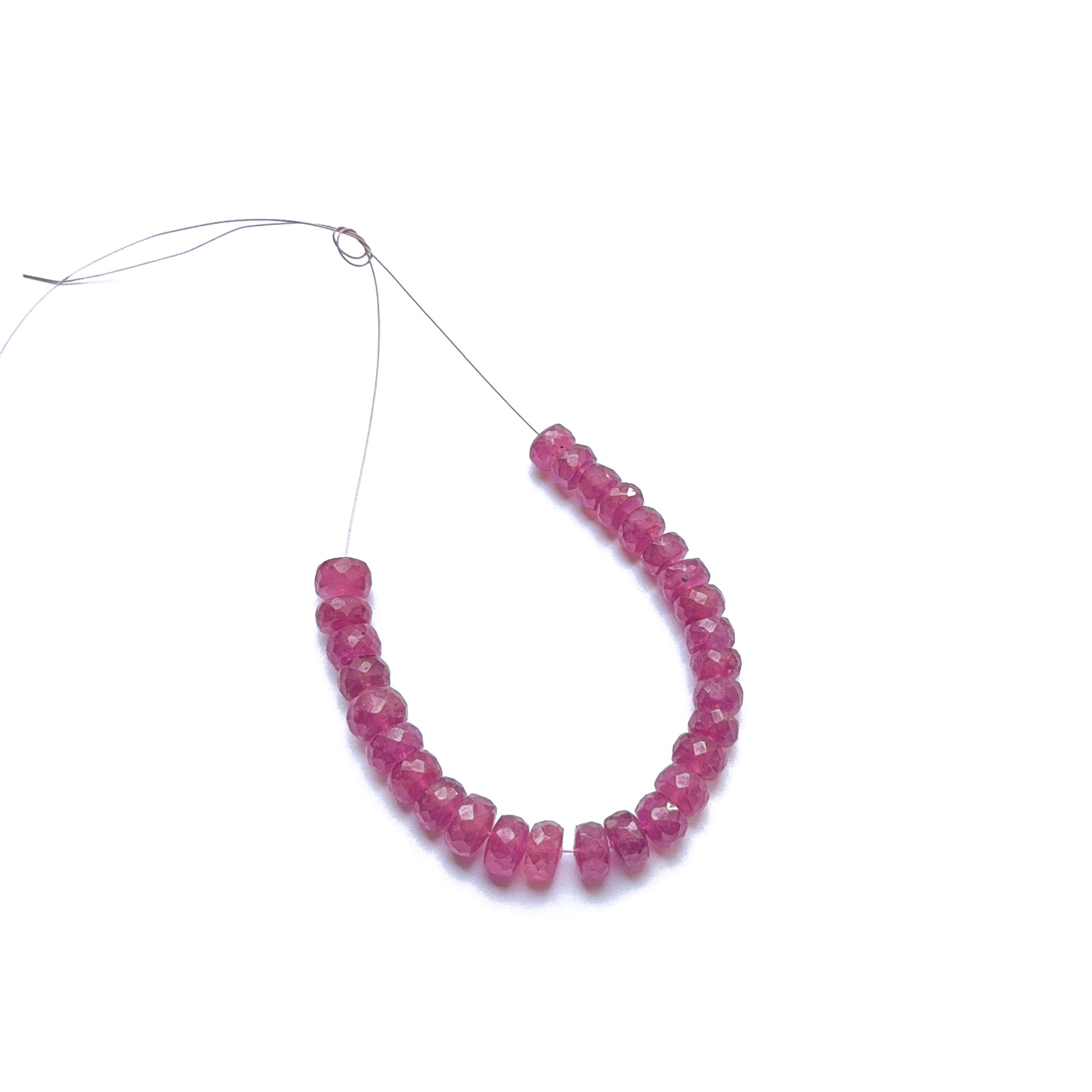 Ruby faceted rondelle beads in deep red tones, showcasing sparkling cuts and gemstone beads for DIY jewellery.