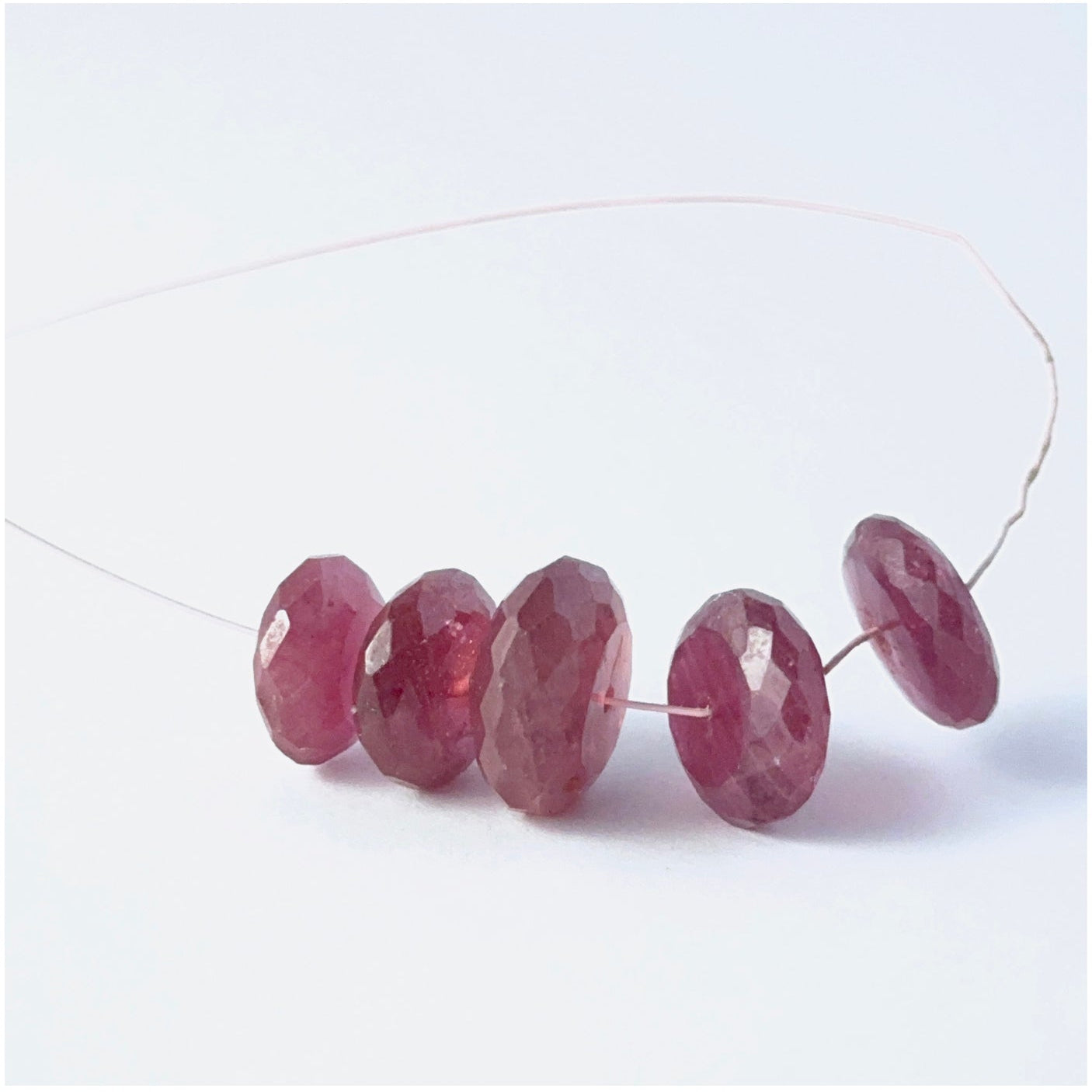 Ruby rondelle beads with genuine red tones and reflective faceting for creative jewellery designs.