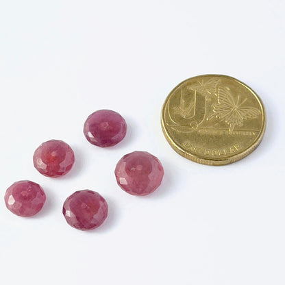 A coin is placed near Ruby beads for scale