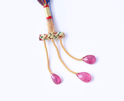 Stone beads made from Ruby teardrops with shimmering faceted surfaces.