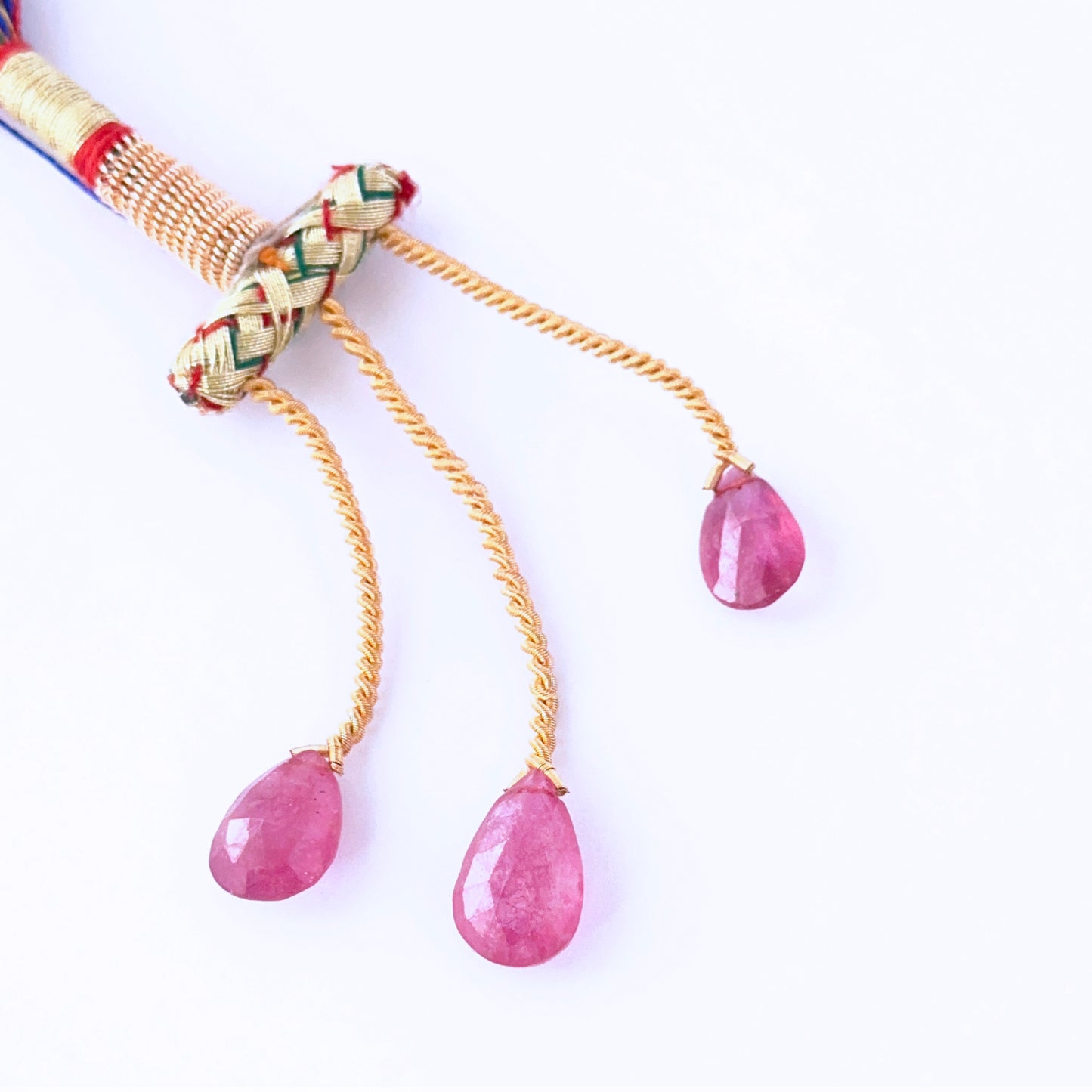  Ruby faceted teardrops showing vivid red sparkle and refined gemstone cuts.
