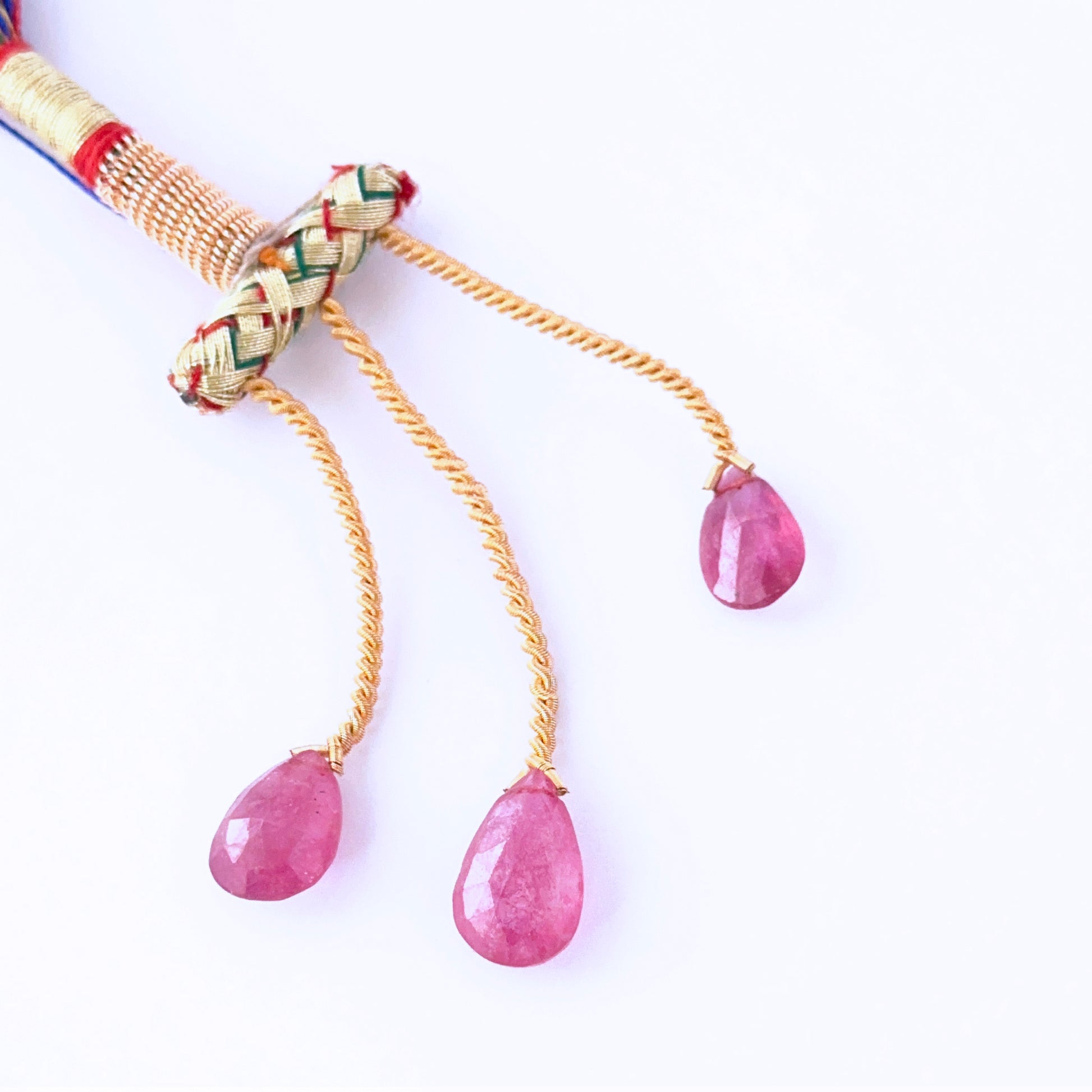  Ruby faceted teardrops showing vivid red sparkle and refined gemstone cuts.