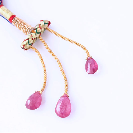  Ruby faceted teardrops showing vivid red sparkle and refined gemstone cuts.